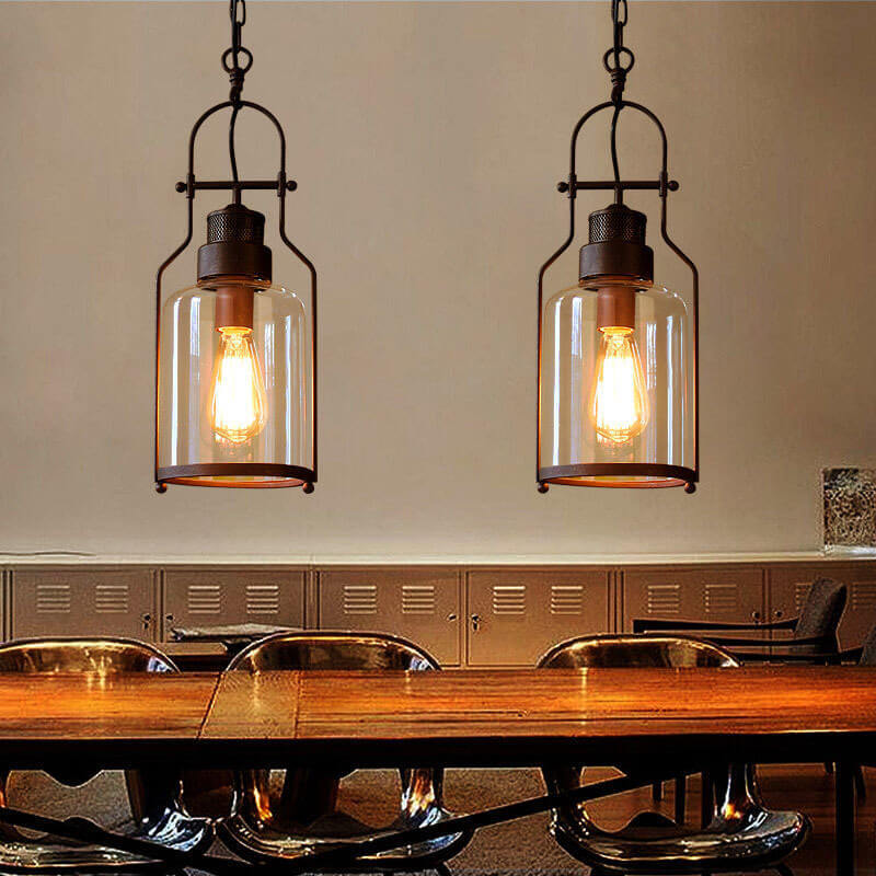 Mason glass jar pendant light with black iron cage over a farmhouse kitchen