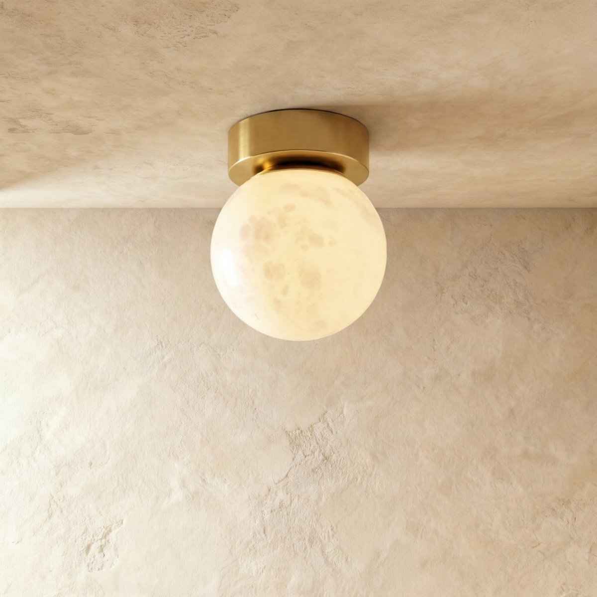 Alabaster and copper ceiling light glowing warmly in a modern room