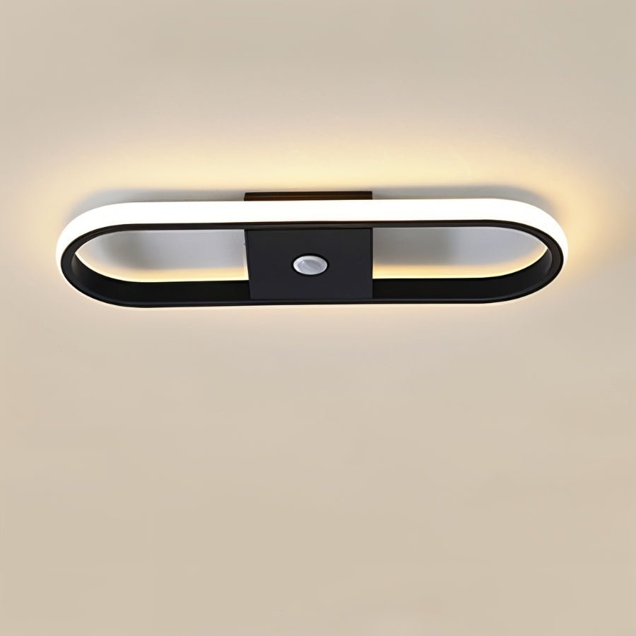 Bright geometric LED ceiling light in a clean garage workspace