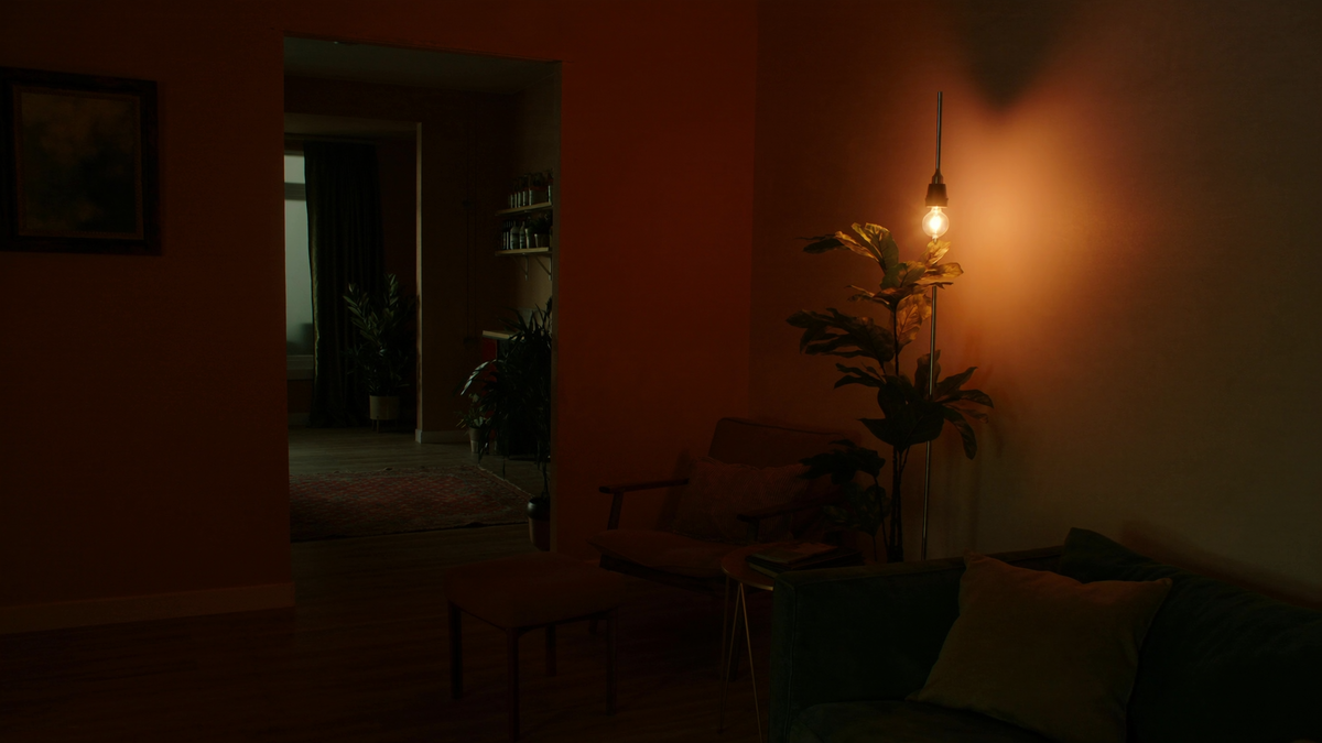 Corner floor lamp glowing warmly in a cozy living room corner at dusk